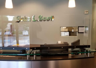 Close-up of sneeze guard at John L Scott Real Estate office.