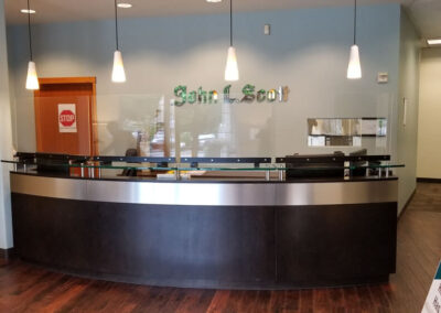 Six custom-sized sneeze guards in a John L. Scott Real Estate office.